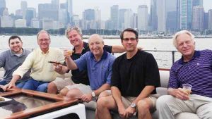 A group of six men on the top deck of a charter yacht in Chicago IL