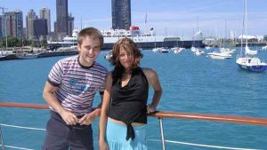 Two teenager posing for a photo on a charter yacht in Chicago IL, you can see Lake Michigan in the background