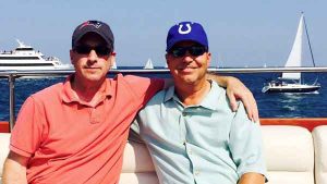 Two men wearing baseball caps on a charter yacht in Chicago IL